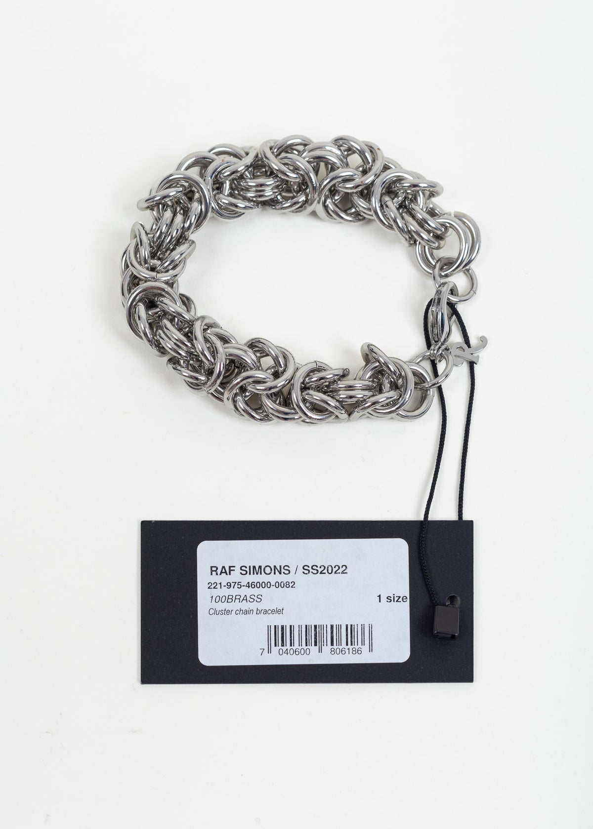 Bracelet with its attached Raf Simons SS2022 hang tag reading Cluster chain bracelet, 100BRASS, 1 size