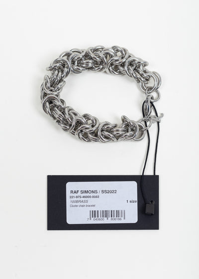 Bracelet with its attached Raf Simons SS2022 hang tag reading Cluster chain bracelet, 100BRASS, 1 size