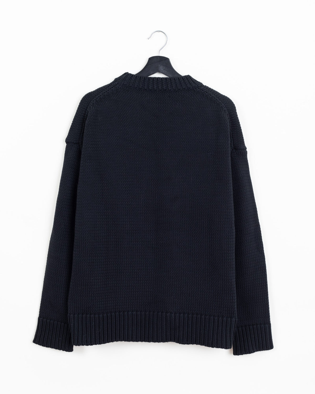 Jil Sander black heavy-knit crewneck sweater, back view showing dropped shoulders and ribbed hem and cuffs