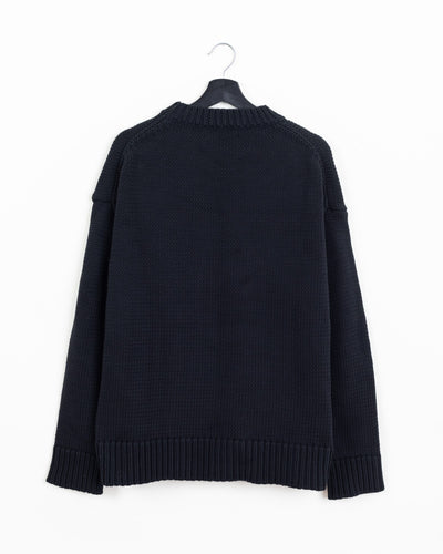 Jil Sander black heavy-knit crewneck sweater, back view showing dropped shoulders and ribbed hem and cuffs