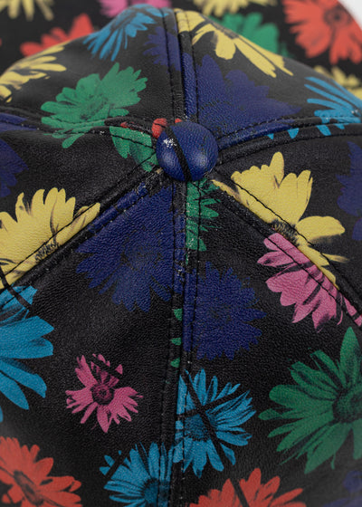 Close-up of the crown where the six printed leather panels meet at the navy covered button, with light crazing to the print