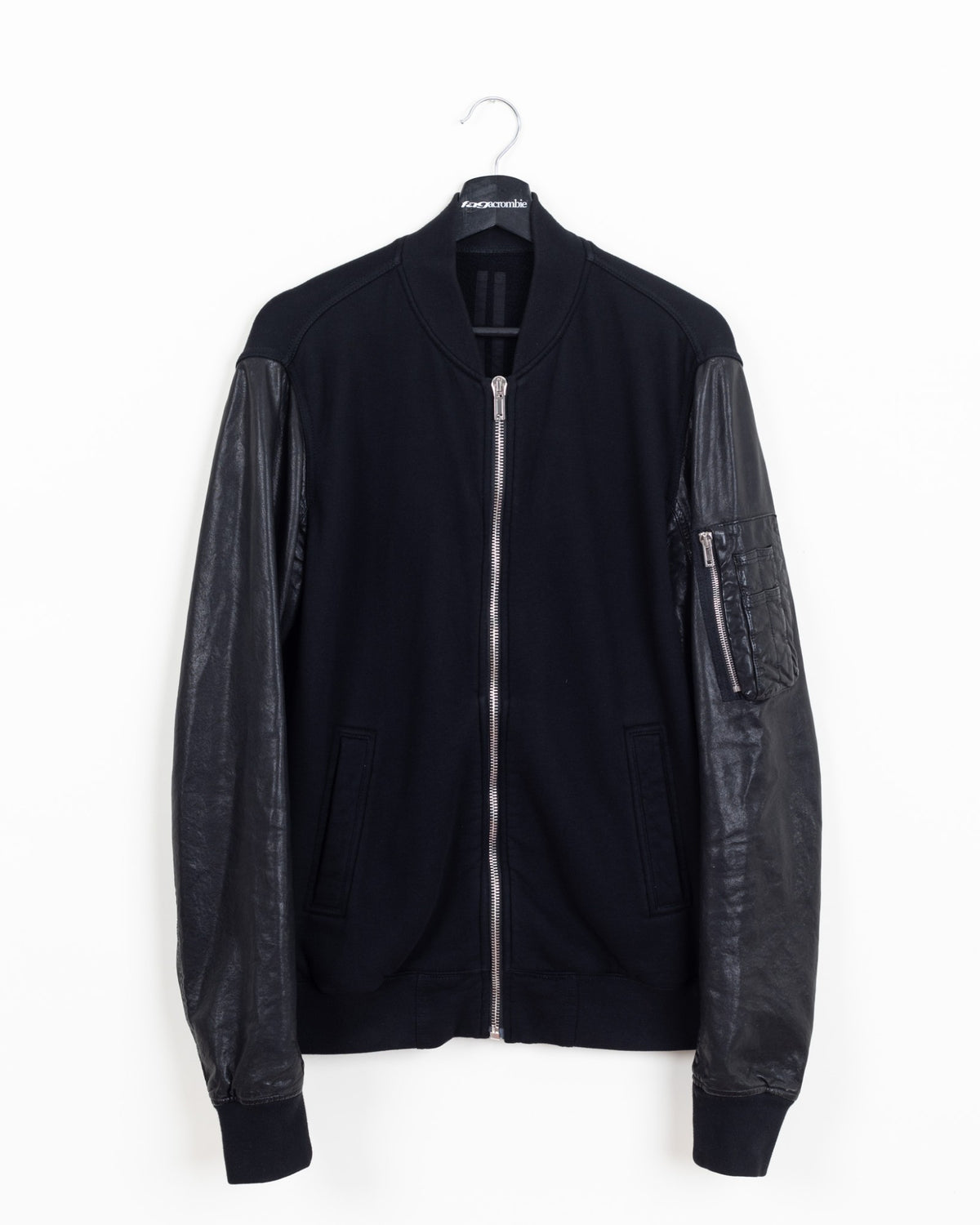 Rick Owens DRKSHDW MA-1 bomber in black cotton fleece with black leather sleeves and silver front zip, front view on hanger