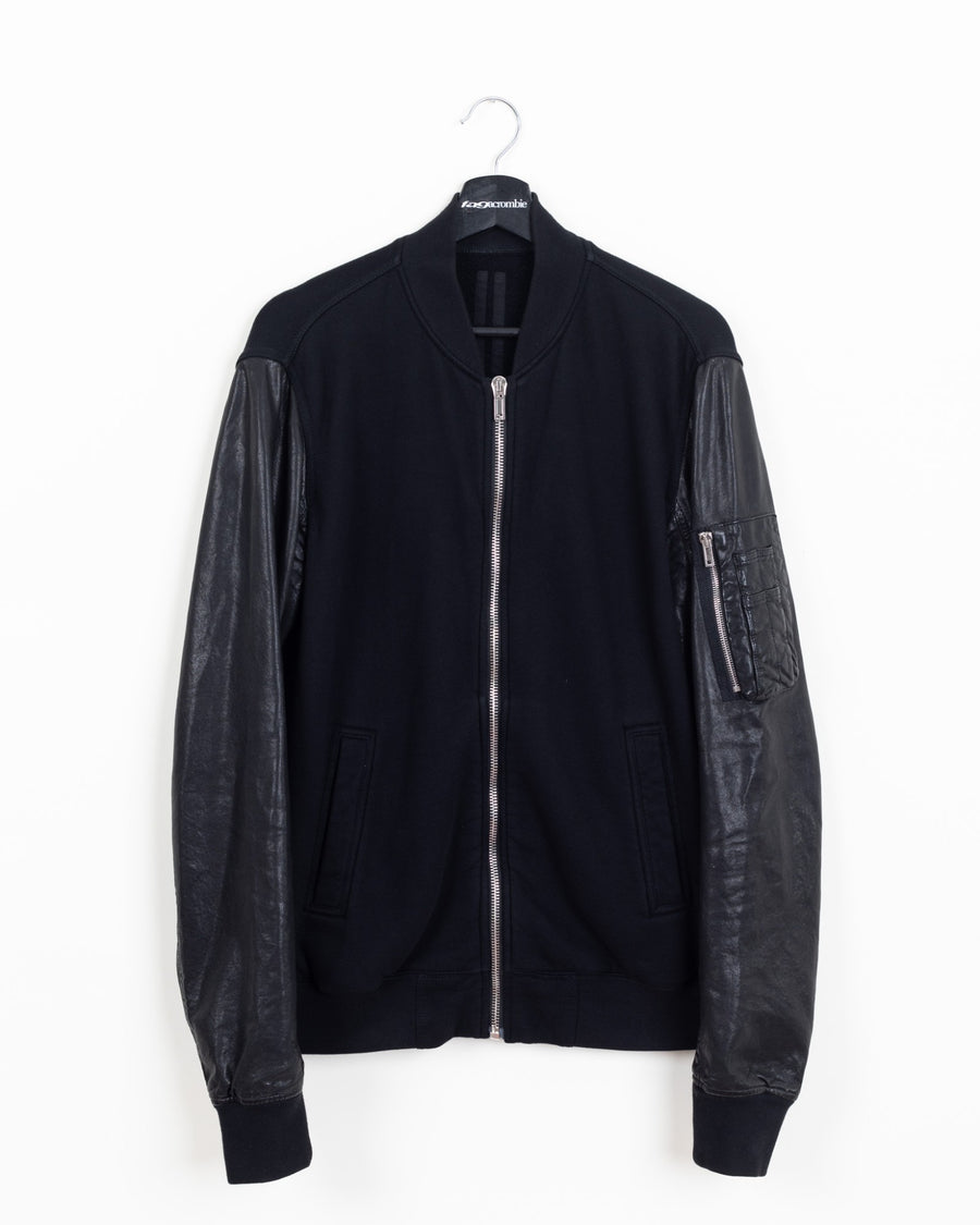 Rick Owens DRKSHDW MA-1 bomber in black cotton fleece with black leather sleeves and silver front zip, front view on hanger